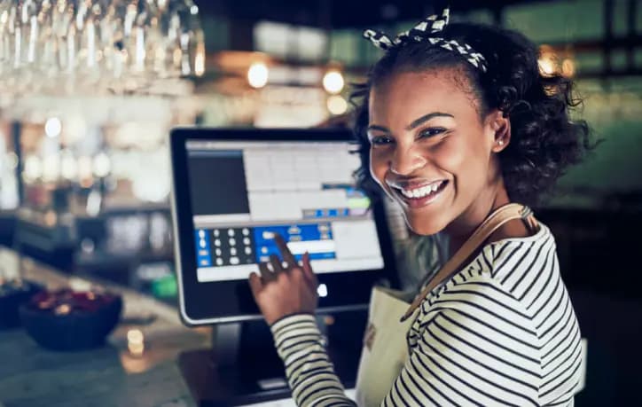 woman smiling at cash register